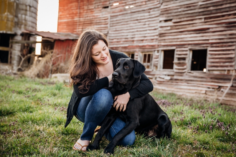 Girl with her dog posing for Senior Portraits