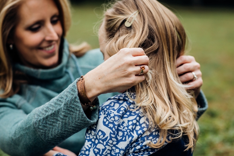mom with her hands in daughters hair
